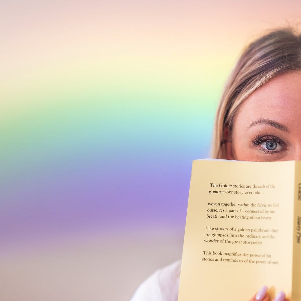 cheerful woman covering face with book